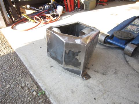 2008 Jeep Wrangler - Custom metal part fabricated in a garage setting, with tools and equipment visible in the background.