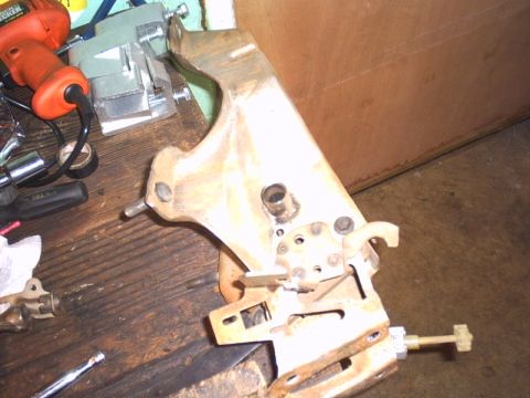 1991 Ford LTD Crown Victoria - A metal pedal assembly with various levers and linkages is shown on a workbench.