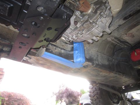 2008 Jeep Wrangler - Close-up of vehicle undercarriage, showing transmission and exhaust modifications.