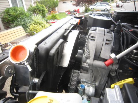 2008 Jeep Wrangler - Close-up of a Jeep Wrangler engine bay, focusing on the radiator and alternator assembly.