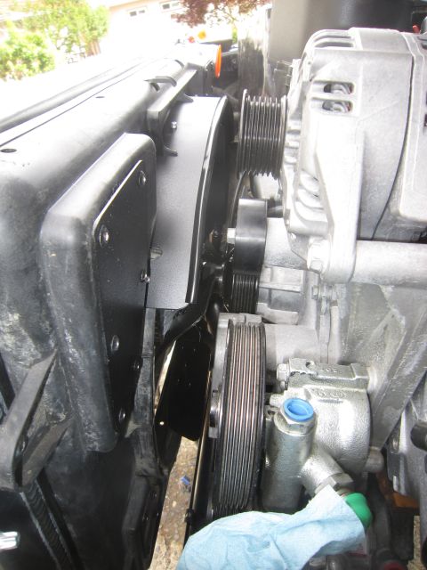 2008 Jeep Wrangler - Engine bay components including pulleys, alternator, and power steering pump are visible.
