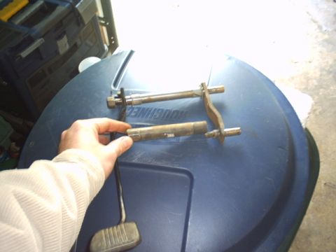 1991 Ford LTD Crown Victoria - Close-up of disassembled pedal assembly parts and a brake pedal, likely for a vehicle.