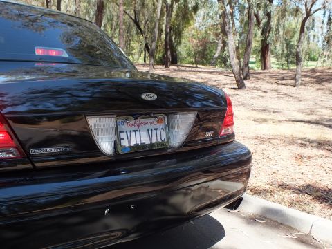 2003 Ford Crown Victoria - Close rear shot showing Police Interceptor badge, Ford oval and plate reading EVIL VTC.