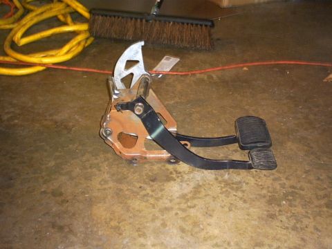 1991 Ford LTD Crown Victoria - This assembly includes the brake and accelerator pedals, mounted on a rusty bracket.