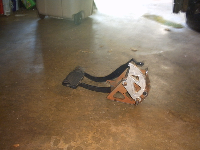 Car brake and accelerator pedals assembly on a concrete floor