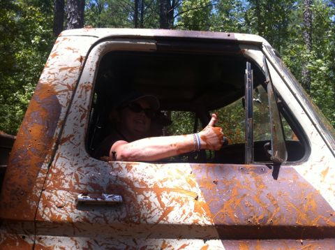 1979 Ford F-150 - Driver gives a thumbs up from inside a heavily mud-splattered truck cab, suggesting off-road adventure.