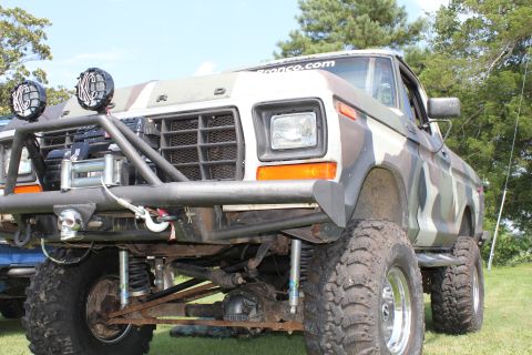 1994 Ford Bronco - This modified Ford truck features a custom bumper, winch, and camouflage paint scheme.