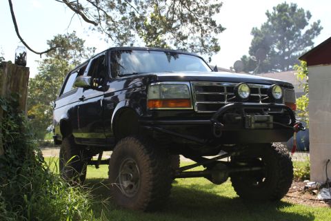 1994 Ford Bronco - This modified Ford Bronco sits high off the ground with large tires and a custom front bumper.