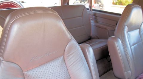 1994 Ford Bronco - Interior view of tan leather seats, including the driver's seat with "Eddie Bauer" script.