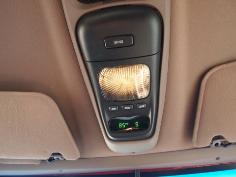 1994 Ford Bronco - Overhead console in a 1994 Ford Bronco shows a garage door opener button and temperature display.