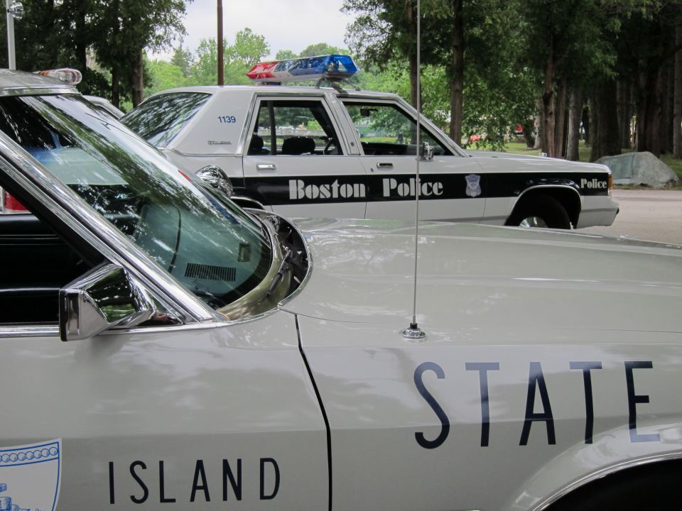 Silver State Police sedan front with Boston Police car behind, close composition