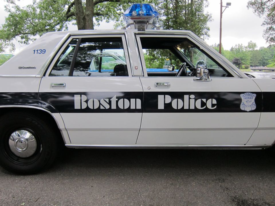 Close side view of white Boston Police Ford sedan, unit 1139, with beacon