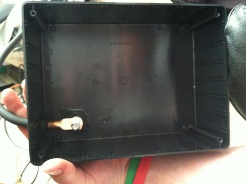 1991 Ford F-250 - A hand holds a black plastic electrical box, showing a single brass terminal and screw.