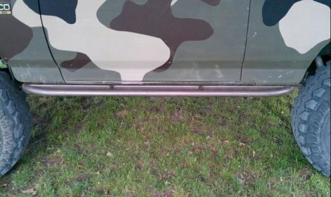 1995 Ford Bronco - This 1995 Ford Bronco features a custom camouflage paint job and aftermarket rock sliders for off-road protection.