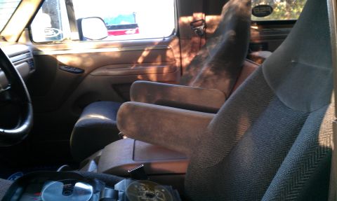 1995 Ford Bronco - The interior of a vehicle is shown, focusing on the seats and dashboard area.