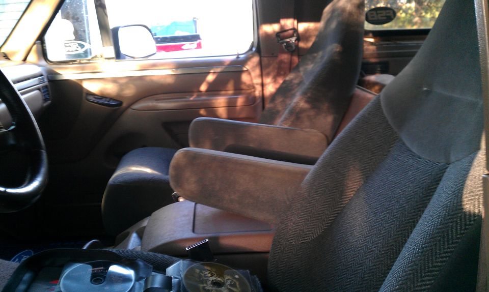 Interior shot of a truck or SUV, showing front seats and door panel