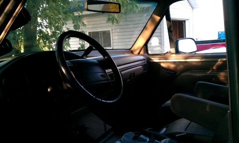 1995 Ford Bronco - Interior view of a vehicle's cabin, showing the dashboard and seating area.