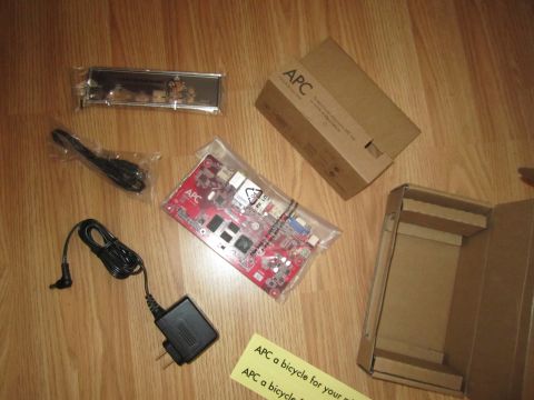 1963 Ford Falcon - Unboxed APC computer components are laid out on a wood-grain surface.
