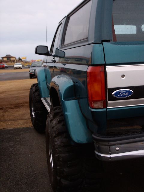 1996 Ford Bronco - Rear view of a lifted 1996 Ford Bronco, modified with oversized tires for off-roading.