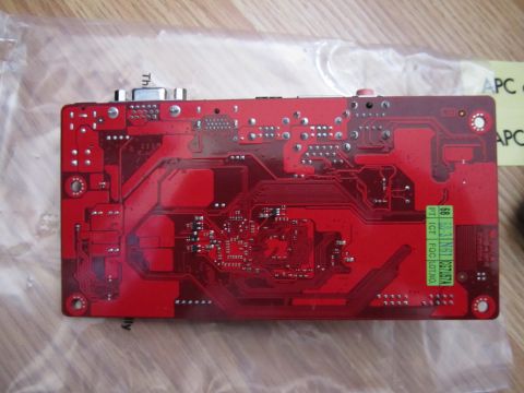 1963 Ford Falcon - A red circuit board with intricate circuitry and various electronic components is shown from the back.