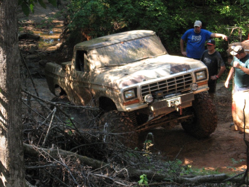 Muddy 1979 Ford F-150 navigating an off-road trail