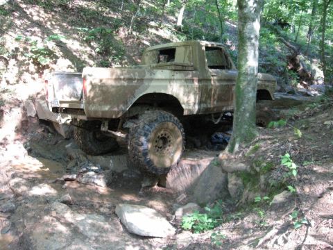 1979 Ford F-150 - This 1979 Ford F-150 is shown off-roading through a challenging muddy and rocky path.