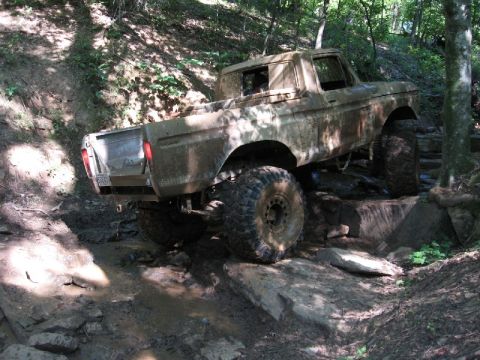1979 Ford F-150 - Ford F-150 tackles an off-road obstacle course with large tires.
