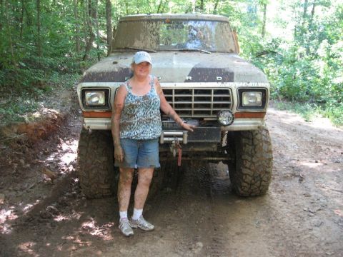 1979 Ford F-150 - A woman poses in front of a heavily muddied Ford F-150 truck, likely after an off-road excursion.