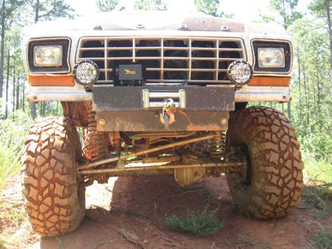 1979 Ford F-150 - A 1979 Ford F-150 with off-road modifications is shown from the front, equipped with a winch and large tires.