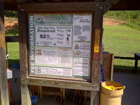 1982 Ford Bronco - Information board details fees and rules for the Panther Top Shooting Range in Nantahala National Forest.