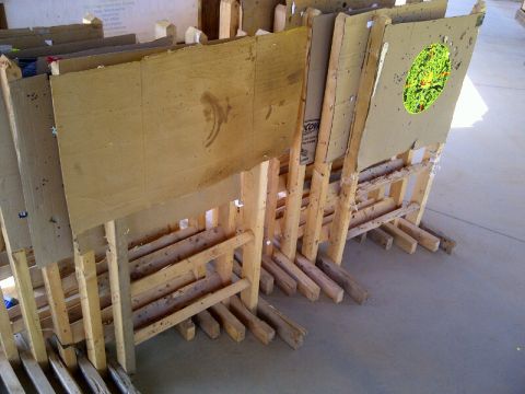 1982 Ford Bronco - Multiple cardboard targets are set up on wooden stands at a shooting range.