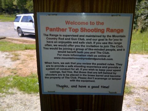 1982 Ford Bronco - Sign at Panther Top Shooting Range details rules and club information, with a white SUV parked nearby.