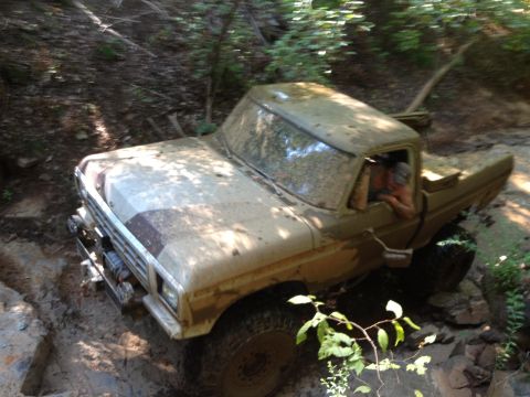 1979 Ford F-150 - A mud-splattered 1979 Ford F-150 navigates a challenging off-road course.
