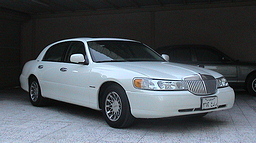 2002 Lincoln Town Car - A white 2002 Lincoln Town Car is parked indoors, showing its front 3/4 view.