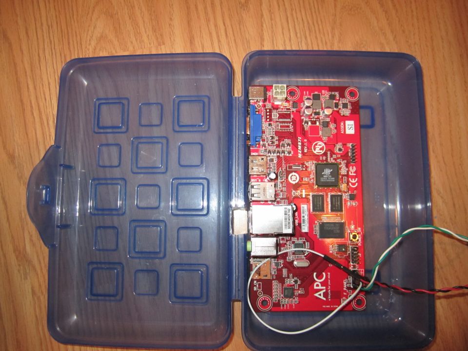 APC circuit board with ports and wires inside a blue plastic case
