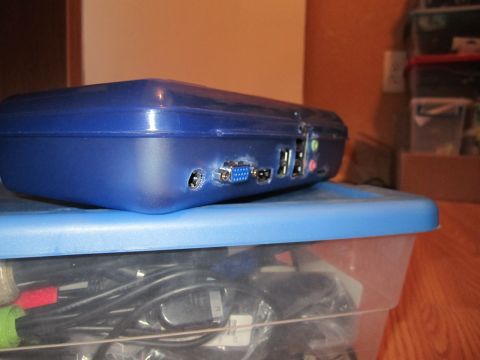 1963 Ford Falcon - A blue computer tower sits on a clear plastic bin filled with cables.