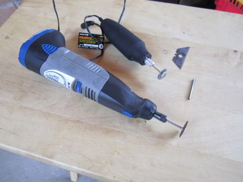 1963 Ford Falcon - Dremel rotary tools and cutting accessories laid out on a wooden table.