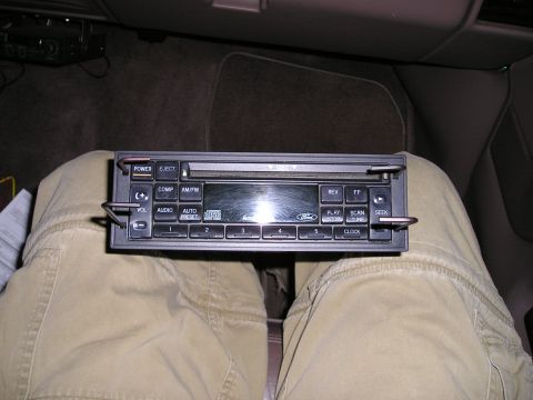 1996 Ford Bronco - Car stereo unit with Ford logo, likely for installation or removal from a vehicle interior.