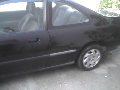2003 Ford Crown Victoria - Side profile of a black coupe, revealing the interior and exterior details.