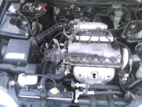 2003 Ford Crown Victoria - Close-up view of a car's engine bay, showing various mechanical parts and wiring.