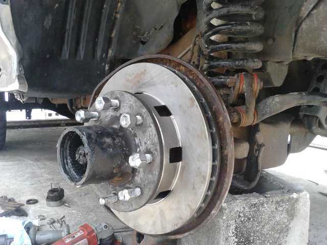 Put the hub/rotor assembly on. Put the first spindle nut on. it will have a little nub on 1 side which points away from the truck. Tighten to 90 lbs while spinning the rotor to seat the bearing. Once seated, back the nut off 1/4 turn and then retorque to 25 lbs. Put the lockwasher on making sure the nub of the that first nut goes fulling into one the the washers many holes. It helps it wipe the grease awya from the nub to see it and the nut might needto slightly be turned to align with the washer. After the washer is in put the second spindle nut on (it wont have the nub like the first nut) and torque it to about 150 lbs.

The idea is that the first nut pets the preload of the wheel bearings. The washer holds the nut in place by locking with the nub of the nut and the notch in the spindle. the third nut just acts to lock the washer and other nut in place.