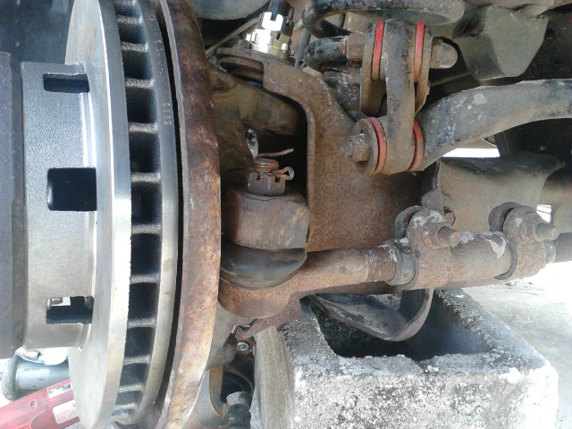 Put the Tierod back on. If the stud just spins, try putting pressure upward. If it still spins try using a jack to force it up with more force

Put the tire back on, do the other side. should be done