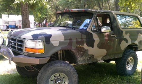 1995 Ford Bronco - This 1995 Ford Bronco is covered in a camouflage paint scheme and appears to be modified for off-road use.