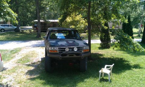 1995 Ford Bronco - This 1995 Ford Bronco is seen in a wooded area with a camouflage paint job and custom front bumper.