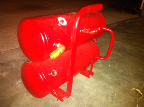 1989 Ford Bronco - Portable air compressor with stacked tanks and a red handle.