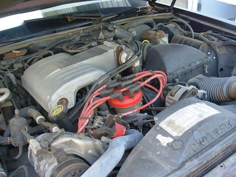 1988 Lincoln Town Car - The engine bay of a 1988 Lincoln Town Car is visible, with a focus on the V8 engine components.