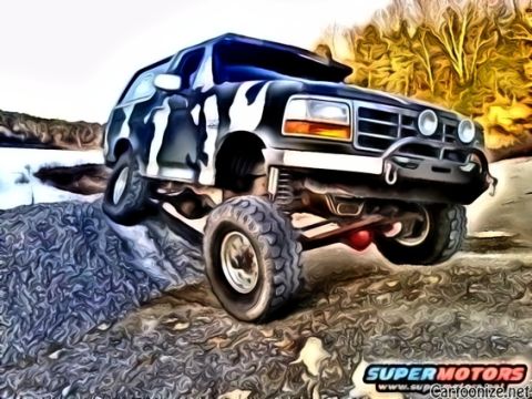 1995 Ford Bronco - This 1995 Ford Bronco is shown tackling a challenging off-road obstacle.