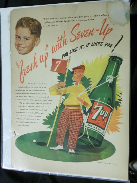 2000 Mercury Grand Marquis - This vintage Seven-Up advertisement depicts a golfer and a young boy, promoting the refreshing beverage.