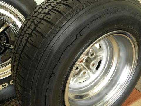 1969 Ford Torino - Close-up of a worn tire with visible cracking on the sidewall, mounted on a polished alloy wheel.