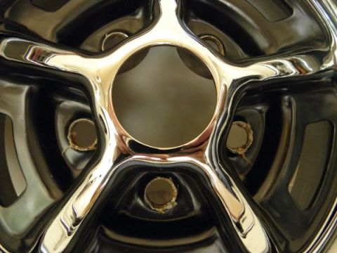 1969 Ford Torino - Close-up of a shiny chrome wheel, a distinctive five-spoke design and a central opening for the hub.